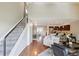 Bright, open living space featuring hardwood floors, bar seating, and staircase at 10550 W Jewell Ave # 301, Lakewood, CO 80232