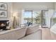 Spacious living room with a fireplace and balcony overlooks the lake at 10550 W Jewell Ave # 301, Lakewood, CO 80232
