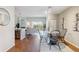 Bright, open living area with hardwood floors, a dining table, and sliding glass doors to a balcony at 10550 W Jewell Ave # 301, Lakewood, CO 80232