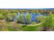Scenic view of a lush pond surrounded by greenery and walking paths at 10550 W Jewell Ave # 301, Lakewood, CO 80232