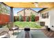 Cozy outdoor patio featuring stylish seating, a fire pit, and views of the fenced backyard at 401 S Ivy St, Denver, CO 80224