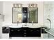 Bright bathroom features dual sinks, modern lighting, and a sleek black vanity with ample storage at 401 S Ivy St, Denver, CO 80224