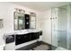 Modern bathroom featuring double sinks and glass-enclosed shower at 401 S Ivy St, Denver, CO 80224