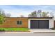 Contemporary home featuring a wood paneled exterior and attached two car garage at 401 S Ivy St, Denver, CO 80224