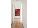 Hallway with colorful wall art and hardwood floors at 401 S Ivy St, Denver, CO 80224