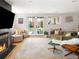 Cozy living room with a fireplace, plush seating, and french doors leading to the backyard at 401 S Ivy St, Denver, CO 80224