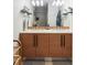 Modern bathroom featuring a double sink vanity, light wood cabinets and modern fixtures at 3420 W 32Nd Ave # 203, Denver, CO 80211