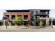 Contemporary mixed-use building featuring brick and metal accents, with retail spaces on the ground floor and residential above at 3420 W 32Nd Ave # 203, Denver, CO 80211