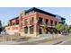 Modern brick building featuring a red outline, street-level retail, and well-designed architecture at 3420 W 32Nd Ave # 203, Denver, CO 80211