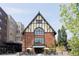 An exterior view of a red brick building with a yellow and black A-frame and large arched windows at 3420 W 32Nd Ave # 203, Denver, CO 80211