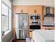 Modern kitchen with stainless steel fridge, microwave, oven, and bright white countertops at 3420 W 32Nd Ave # 203, Denver, CO 80211