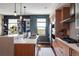 Well-lit kitchen featuring wooden cabinets, stainless steel appliances, and stylish pendant lighting at 3420 W 32Nd Ave # 203, Denver, CO 80211