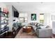 Bright living room with large sectional sofa, stylish round coffee table, fireplace, and shelving, creating a cozy ambiance at 3420 W 32Nd Ave # 203, Denver, CO 80211