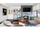 Cozy living room features a fireplace, TV, guitar, dart board, and a comfortable seating arrangement at 3420 W 32Nd Ave # 203, Denver, CO 80211