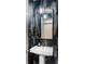 Stylish powder room with designer wallpaper, modern fixtures, and a pedestal sink at 3420 W 32Nd Ave # 203, Denver, CO 80211