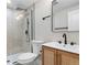 Modern bathroom boasts a glass-enclosed shower and vanity with black faucet and matching accents at 8079 W 67Th Ave, Arvada, CO 80004