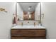 Bathroom featuring double sink vanity with modern wood cabinets and bronze hardware at 8079 W 67Th Ave, Arvada, CO 80004