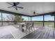 A covered deck features a dining table and chairs with views of the surrounding landscape at 8079 W 67Th Ave, Arvada, CO 80004