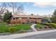 A charming single-story brick home boasts a well-kept lawn and a relaxing outdoor deck at 8079 W 67Th Ave, Arvada, CO 80004