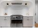 Modern kitchen with stainless steel range, white countertops, and stylish cabinetry at 8079 W 67Th Ave, Arvada, CO 80004