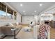 Bright and airy living room showcasing hardwood floors, modern furniture, and seamless kitchen access at 8079 W 67Th Ave, Arvada, CO 80004