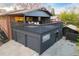 Rear exterior view of home showcasing an elevated deck above a three-car garage and exterior stair access at 8079 W 67Th Ave, Arvada, CO 80004