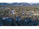 Aerial view showing home surrounded by trees and mountains at 5925 Herzman Dr, Evergreen, CO 80439