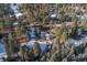 Aerial view of a cabin situated in a snowy, wooded area at 5925 Herzman Dr, Evergreen, CO 80439