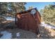 Exterior view of a wooden shed with satellite dish at 5925 Herzman Dr, Evergreen, CO 80439