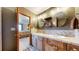 Bathroom with double vanity, tile countertops, and view of bedroom at 6301 Perry Park Blvd # 22, Larkspur, CO 80118