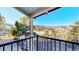 Serene deck view overlooking mountains and icy lake, framed by lush trees and blue skies at 6301 Perry Park Blvd # 22, Larkspur, CO 80118