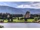 Picturesque golf course on a lake with rock formations and mountain views in the background at 6301 Perry Park Blvd # 22, Larkspur, CO 80118