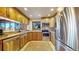 Well-lit kitchen with wood cabinets, stainless steel appliances, and a window above the sink at 6301 Perry Park Blvd # 22, Larkspur, CO 80118