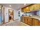 Features wooden cabinets and stainless steel dishwasher next to half bath at 6301 Perry Park Blvd # 22, Larkspur, CO 80118