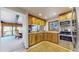 Cozy kitchen featuring warm wood cabinetry, granite countertops, and stainless steel appliances at 6301 Perry Park Blvd # 22, Larkspur, CO 80118