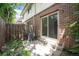 Brick patio with a wooden fence, a sliding door, and an air conditioner at 6920 W 48Th Ave, Wheat Ridge, CO 80033