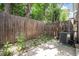 Small backyard features a patio area, small rock garden, wooden fence, and green shrubs at 6920 W 48Th Ave, Wheat Ridge, CO 80033