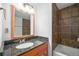 Modern bathroom featuring granite counters, an updated shower, and an updated vanity at 6920 W 48Th Ave, Wheat Ridge, CO 80033