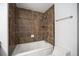 The bathroom features a tub with tile surround, a showerhead, and a white toilet at 6920 W 48Th Ave, Wheat Ridge, CO 80033