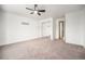 A carpeted bedroom with a mirrored closet and a ceiling fan provides ample space at 6920 W 48Th Ave, Wheat Ridge, CO 80033