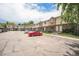 Exterior view of townhomes with a red car in the parking lot on a sunny day at 6920 W 48Th Ave, Wheat Ridge, CO 80033