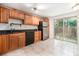Kitchen featuring wooden cabinets and stainless steel appliances, adjacent to backyard access at 6920 W 48Th Ave, Wheat Ridge, CO 80033