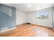 Bright living room with hardwood floors and a large window providing plenty of natural light at 6920 W 48Th Ave, Wheat Ridge, CO 80033