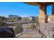 Outdoor balcony featuring an upscale grill with views of nearby buildings and landscaping at 7865 Vallagio Ln # 308, Englewood, CO 80112