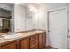 Bathroom featuring double sinks, a large mirror, and a tiled shower at 7865 Vallagio Ln # 308, Englewood, CO 80112