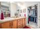 Double vanity bathroom with large closet and tile flooring at 7865 Vallagio Ln # 308, Englewood, CO 80112