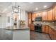 Beautiful kitchen with granite countertops, wood floors, updated cabinets, and stainless steel appliances at 7865 Vallagio Ln # 308, Englewood, CO 80112