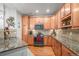 Modern kitchen featuring granite countertops and ample cabinetry at 7865 Vallagio Ln # 308, Englewood, CO 80112