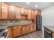 Bright kitchen showcasing wood cabinets, dark stainless steel appliances, and beautiful granite countertops at 7865 Vallagio Ln # 308, Englewood, CO 80112