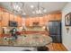 Well-equipped kitchen with granite countertops and wood cabinets at 7865 Vallagio Ln # 308, Englewood, CO 80112